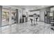 Spacious kitchen with white cabinetry, stainless steel appliances, marble flooring, and a sliding glass door at 4870 E Colorado Ave, Las Vegas, NV 89104