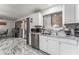 Well-lit kitchen with stainless steel appliances, white cabinets, marble countertops, and a large window at 4870 E Colorado Ave, Las Vegas, NV 89104