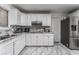 Bright kitchen featuring white cabinets, stainless steel appliances, and elegant marble countertops and flooring at 4870 E Colorado Ave, Las Vegas, NV 89104