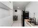 Compact kitchenette with stainless steel sink, appliances, and a dining area at 4870 E Colorado Ave, Las Vegas, NV 89104