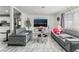Stylish living room with marble floors, comfortable gray couches, and a modern entertainment center at 4870 E Colorado Ave, Las Vegas, NV 89104