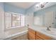 Comfortable bathroom with a large tub, window and vanity at 5068 Jeffreys St # 202, Las Vegas, NV 89119