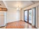 Bright dining area with hardwood floors, chandelier, and glass doors leading to a private outdoor space at 5068 Jeffreys St # 202, Las Vegas, NV 89119