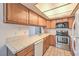 Well-lit kitchen with stainless steel appliances and wooden cabinetry at 5068 Jeffreys St # 202, Las Vegas, NV 89119