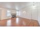 Bright living room with fireplace, hardwood floors, and natural light from two windows at 5068 Jeffreys St # 202, Las Vegas, NV 89119