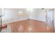 Spacious living room with hardwood floors, fireplace, and unique round window at 5068 Jeffreys St # 202, Las Vegas, NV 89119
