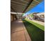 Private backyard featuring a covered patio with an adjacent strip of artificial turf at 5594 Ricochet Ave, Las Vegas, NV 89110