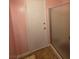 Bathroom featuring a walk-in shower and a door, with pink walls and neutral tiled flooring at 5594 Ricochet Ave, Las Vegas, NV 89110