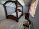 An ornate four-poster bed stands in a light filled room with white floors and lavender walls at 5594 Ricochet Ave, Las Vegas, NV 89110