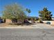 Single-story home featuring desert landscaping, solar panels, and an expansive driveway on a sunny day at 5594 Ricochet Ave, Las Vegas, NV 89110