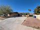 Single-story home featuring desert landscaping, solar panels, and an expansive driveway on a sunny day at 5594 Ricochet Ave, Las Vegas, NV 89110