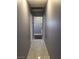 Hallway with gray walls and white tile flooring leading into connected rooms at 5594 Ricochet Ave, Las Vegas, NV 89110