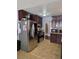 Stainless steel appliances, dark cabinets and tile floors in this kitchen at 5594 Ricochet Ave, Las Vegas, NV 89110