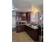 Traditional kitchen with dark cabinets, tile floors and stainless steel appliances at 5594 Ricochet Ave, Las Vegas, NV 89110