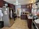 This kitchen has dark cabinets, tile floors, and stainless steel appliances at 5594 Ricochet Ave, Las Vegas, NV 89110