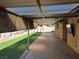 Covered patio with artificial grass and concrete flooring, providing ample outdoor space at 5594 Ricochet Ave, Las Vegas, NV 89110
