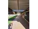 Large covered patio featuring a concrete floor and artificial grass, perfect for outdoor living at 5594 Ricochet Ave, Las Vegas, NV 89110