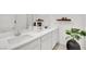 Modern bathroom with dual sinks, white countertops, dark cabinets, and decorative accents at 600 N Carriage Hill Dr # 1008, Las Vegas, NV 89138