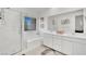 Bright bathroom with double sinks, a glass-enclosed shower, and tile flooring at 600 N Carriage Hill Dr # 1008, Las Vegas, NV 89138