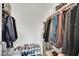 Walk-in closet with clothes hanging on rods and shoes on a rack at 600 N Carriage Hill Dr # 1008, Las Vegas, NV 89138