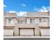 Modern townhome exterior showcasing multiple garage doors and a well maintained facade at 600 N Carriage Hill Dr # 1008, Las Vegas, NV 89138