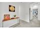 Hallway with a console table, art pieces and an open view to a bright living space at 600 N Carriage Hill Dr # 1008, Las Vegas, NV 89138