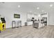 Open living space with kitchen, bar seating, and game area with modern accents at 600 N Carriage Hill Dr # 1008, Las Vegas, NV 89138