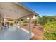 Large covered patio and landscape design with well-manicured plants and trees at 6131 Cozy Creek St, North Las Vegas, NV 89031
