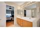 Well-lit bathroom featuring double sinks and an open doorway to bedroom at 6131 Cozy Creek St, North Las Vegas, NV 89031