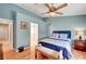 Serene blue bedroom features a plush bed, ensuite bathroom, and hardwood flooring at 6131 Cozy Creek St, North Las Vegas, NV 89031