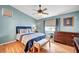 Bedroom with hardwood floors, blue accents, and a ceiling fan and natural light at 6131 Cozy Creek St, North Las Vegas, NV 89031