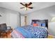 Bedroom featuring light gray walls, wood-look flooring, and a blue chair at 6131 Cozy Creek St, North Las Vegas, NV 89031