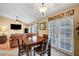 Inviting dining area with dark wood furniture, chandelier, and direct access to the backyard at 6131 Cozy Creek St, North Las Vegas, NV 89031