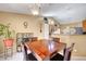 Well-lit dining area featuring a wood table, chairs, and stylish decor with view of kitchen at 6131 Cozy Creek St, North Las Vegas, NV 89031