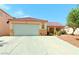 Charming single-story home with a well-maintained lawn and attached two-car garage at 6131 Cozy Creek St, North Las Vegas, NV 89031