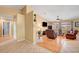 Open living space with fireplace, TV, ceiling fan, and tile and wood flooring at 6131 Cozy Creek St, North Las Vegas, NV 89031