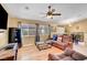 Cozy living room features a ceiling fan, hardwood flooring, and comfortable seating arrangement at 6131 Cozy Creek St, North Las Vegas, NV 89031