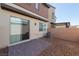 Private backyard featuring a brick patio, gravel landscaping, privacy wall, and access to the home's interior at 6145 May River St, Las Vegas, NV 89148