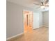 Bedroom with hardwood floors, ceiling fan, and white doors at 6145 May River St, Las Vegas, NV 89148