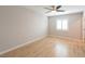 Bright, empty bedroom with ceiling fan and hardwood floors and window at 6145 May River St, Las Vegas, NV 89148