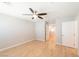 Bedroom with hardwood floors, ceiling fan, and white doors at 6145 May River St, Las Vegas, NV 89148