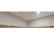 Neutral closet space with a wooden hanging bar ready to organize and store clothes and accessories at 6145 May River St, Las Vegas, NV 89148