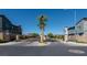 Gated community entrance with lush landscaping, mature palm trees, and secure access for residents at 6145 May River St, Las Vegas, NV 89148