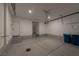 Spacious garage with epoxy floors, recessed lighting, storage shelves, and ample room for vehicles at 6145 May River St, Las Vegas, NV 89148