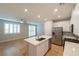 Bright kitchen with island, stainless steel appliances, modern cabinets, and lots of natural light at 6145 May River St, Las Vegas, NV 89148