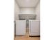 Convenient laundry room with modern washer and dryer and built-in shelf for storage at 6145 May River St, Las Vegas, NV 89148