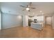 Open concept living room and kitchen with hardwood floors and ceiling fan at 6145 May River St, Las Vegas, NV 89148