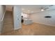 Open-concept living area with stairs, kitchen, wood floors and lots of natural light at 6145 May River St, Las Vegas, NV 89148