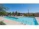 Community pool with sparkling blue water, lounge chairs, and shaded seating areas for relaxation at 6145 May River St, Las Vegas, NV 89148