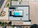 Aerial view of the property with a geometric pool, sun loungers, an outdoor kitchen, and a large lot at 647 Foxhall Rd, Henderson, NV 89002